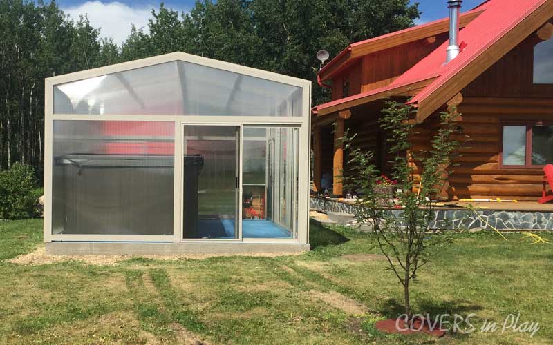 Exterior view of freestanding swim spa pool dome in Barrhead, AB, with a
            sliding door for easy entry.